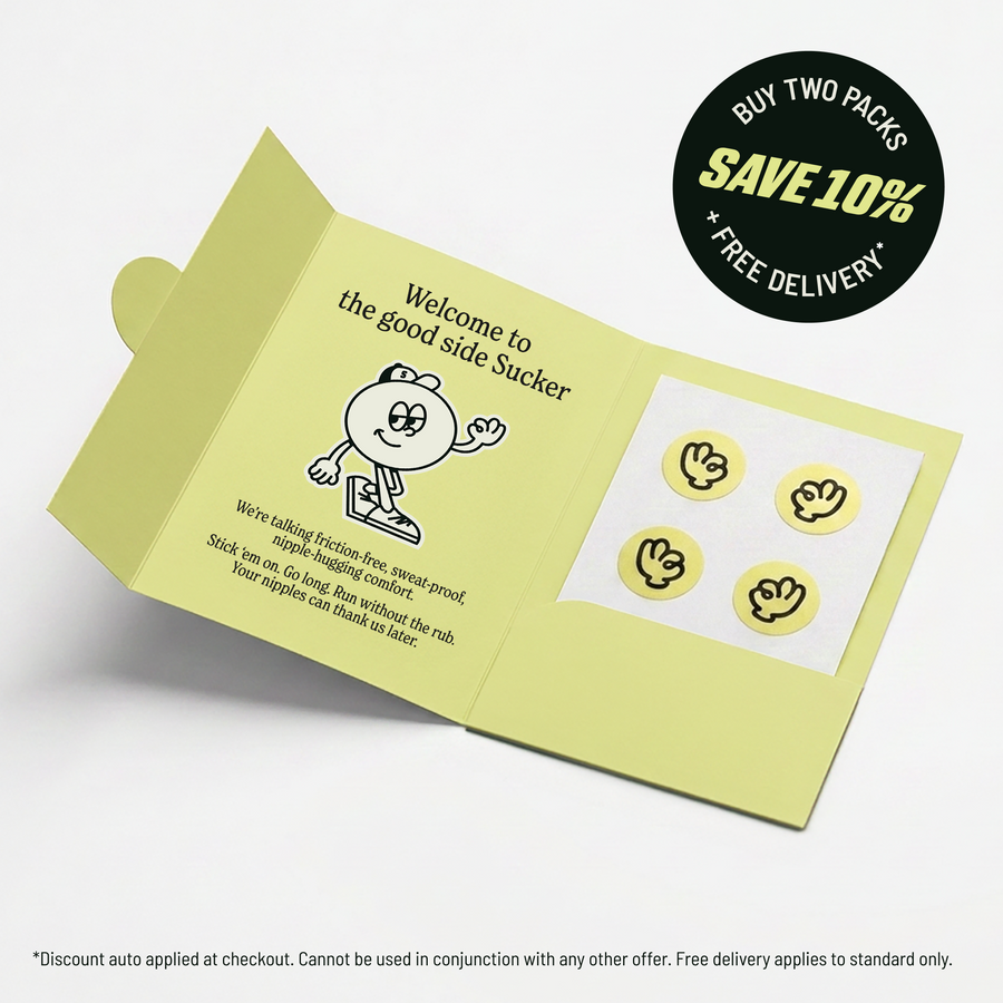 An open Suckers pack showing a sheet of four anti-chafe nipple stickers alongside the printed welcome message and the Suckers mascot character