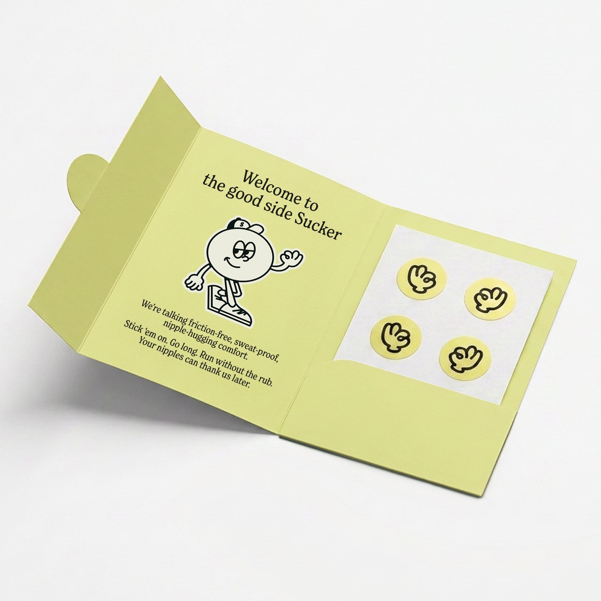 An open Suckers pack showing a sheet of four anti-chafe nipple stickers alongside the printed welcome message and the Suckers mascot character